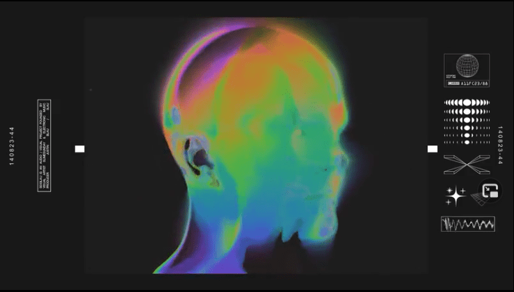 A face made up of bright shapeshifting colors spins slowly